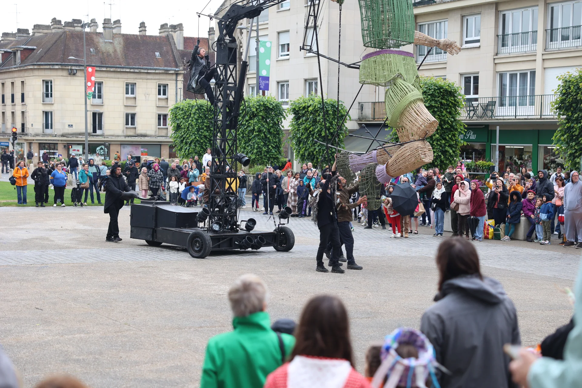 La structure de manipulation et les marionnettistes accompagnent Plume devant le public à Beauvais.